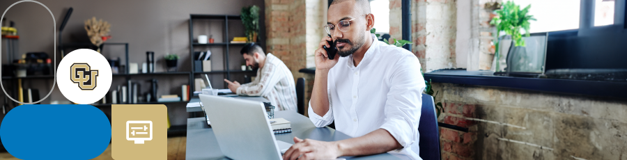 Sitting with a phone in his hand and open computer Mapping Your Path to CISSP Certification