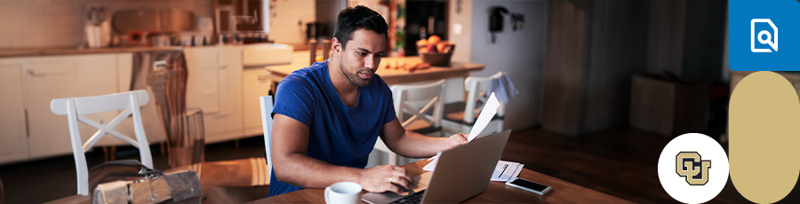 Working on the computer and holding a paper in his hand - Preparing for the A+ certification exams
