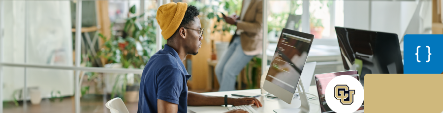 sitting in an office typing on his computer and looking at the Rising Demand for AWS Security Professionals